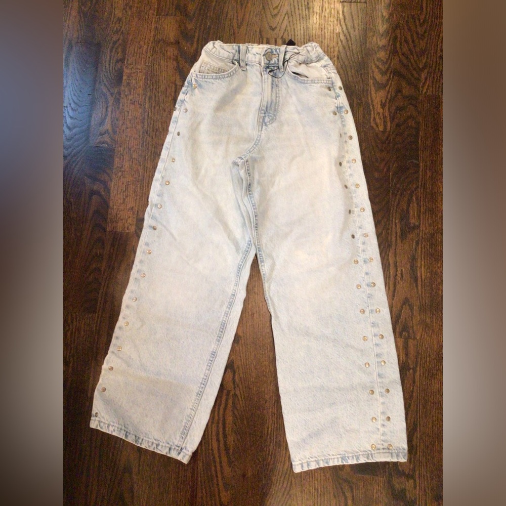 Primark - light-wash wide-leg jeans featuring side metal stud details.